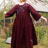 The Double Take Dress in Berry Linen with ribbon appliquè