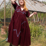 The Double Take Dress in Berry Linen with ribbon appliquè